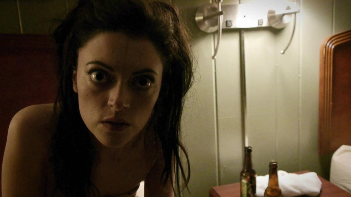 Photo from V/H/S - Hired to steal a rare VHS tape from a secluded house, a group of petty crooks breaks in and discovers a corpse surrounded by TVs and stacks of tapes. Now they must watch each horrific and bizarre video as they search for the correct one