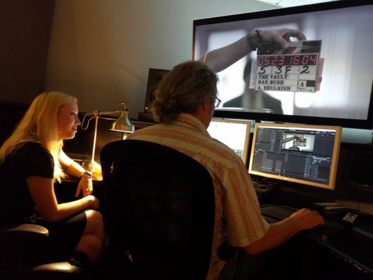 Photo of John Petersen and Caroline Oelkers checking sound sync on The Vault's feature Dailies pass at Moonshine Post Production in Atlanta Georgia