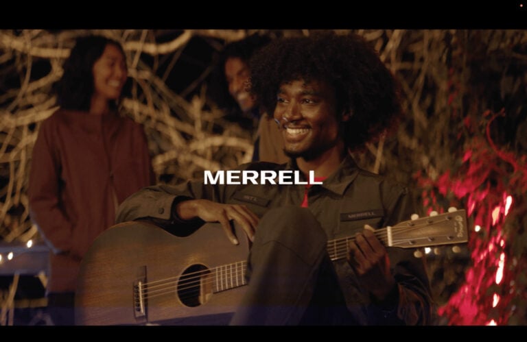 Musician with guitar wearing Merrell, colored by Moonshine Post